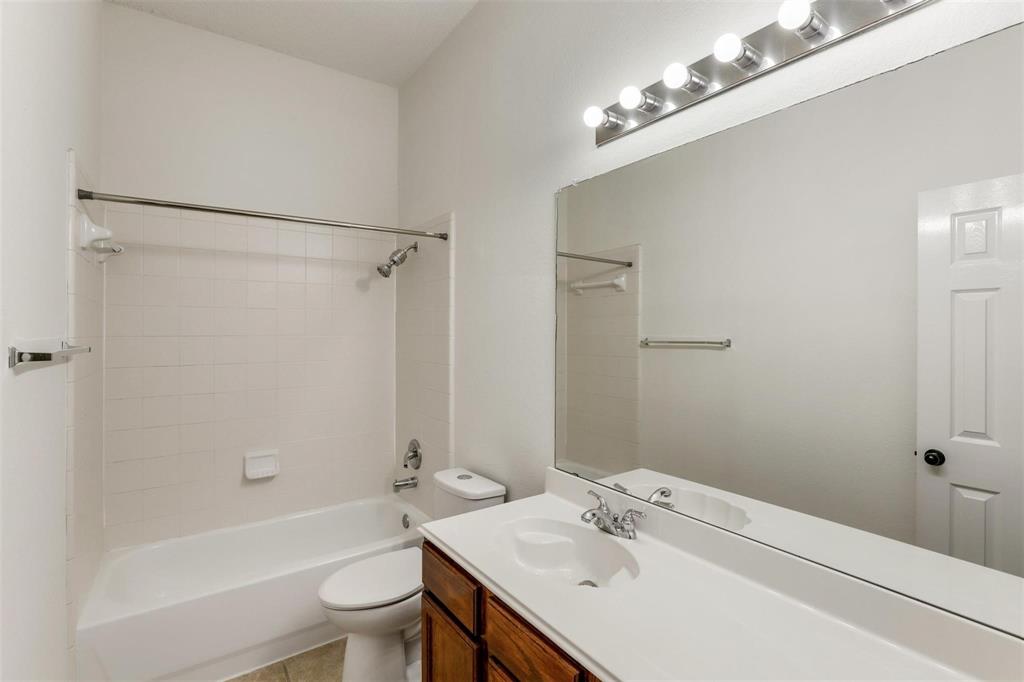 9914 Golden Rod Drive Frisco, TX 75035 - Photo 8 of 18 a bathroom with a sink toilet and shower