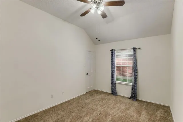 an empty room with closet and windows
