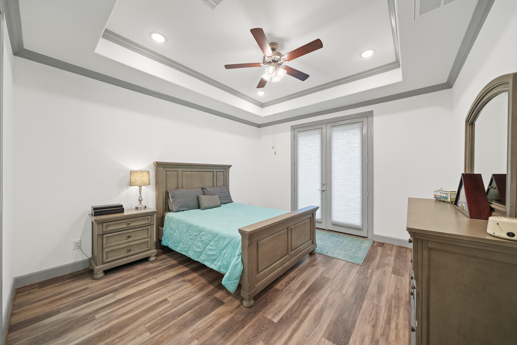 5739 Bobwhite Trail Manvel, TX 77578 - Photo 15 of 29 Large windows invite soft natural light into this relaxing primary bedroom, creating a bright and tranquil atmosphere. There's plenty of room to personalize the space to fit your style.