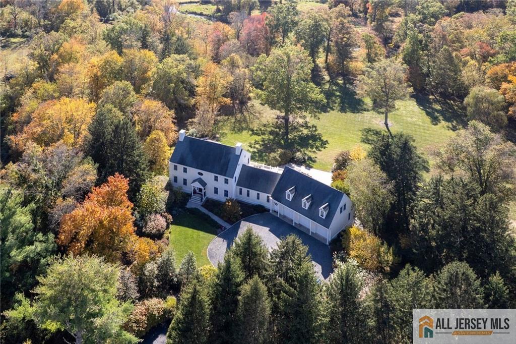 213 Cranbury Neck Road Plainsboro, NJ 08512 - Photo 1 of 52 a view of a street with houses and a bench