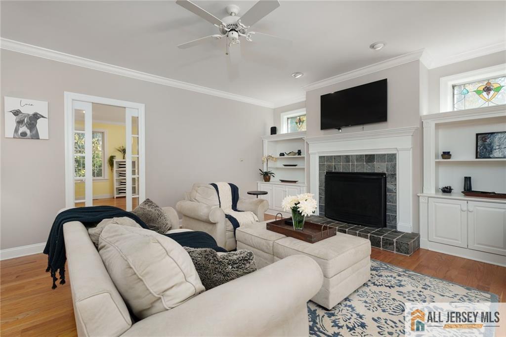 213 Cranbury Neck Road Plainsboro, NJ 08512 - Photo 11 of 52 a living room with furniture a fireplace and a flat screen tv