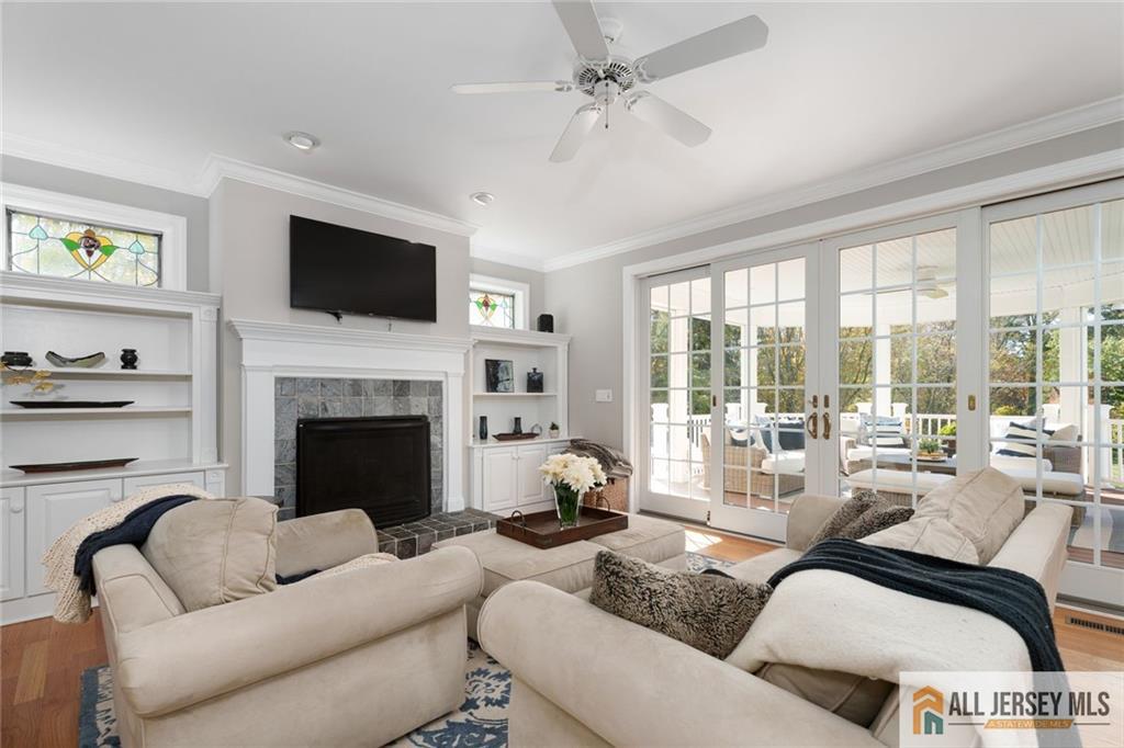213 Cranbury Neck Road Plainsboro, NJ 08512 - Photo 12 of 52 a living room with furniture fireplace and a flat screen tv