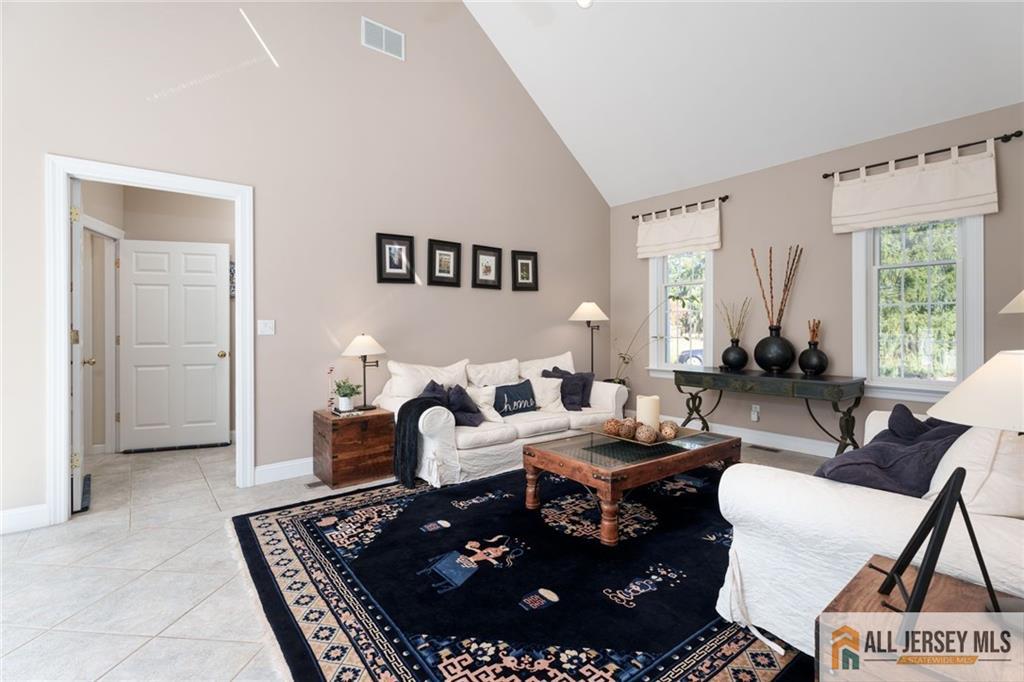 213 Cranbury Neck Road Plainsboro, NJ 08512 - Photo 13 of 52 a living room with furniture and a large window