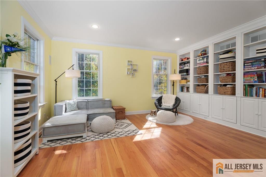 213 Cranbury Neck Road Plainsboro, NJ 08512 - Photo 15 of 52 a living room with furniture and a book shelf