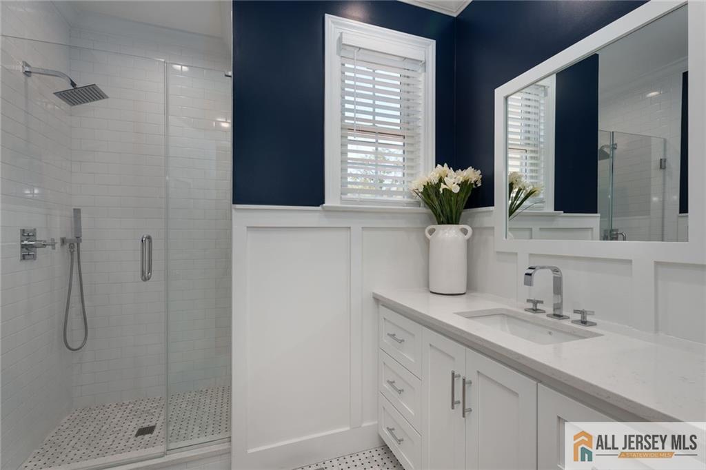 213 Cranbury Neck Road Plainsboro, NJ 08512 - Photo 16 of 52 a bathroom with a shower sink and mirror