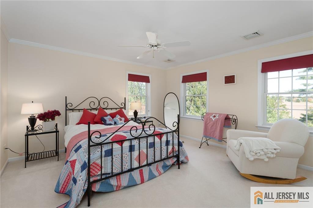 213 Cranbury Neck Road Plainsboro, NJ 08512 - Photo 20 of 52 a bedroom with furniture and a chandelier