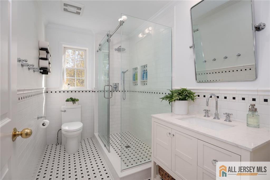 213 Cranbury Neck Road Plainsboro, NJ 08512 - Photo 22 of 52 a bathroom with a sink a toilet and shower