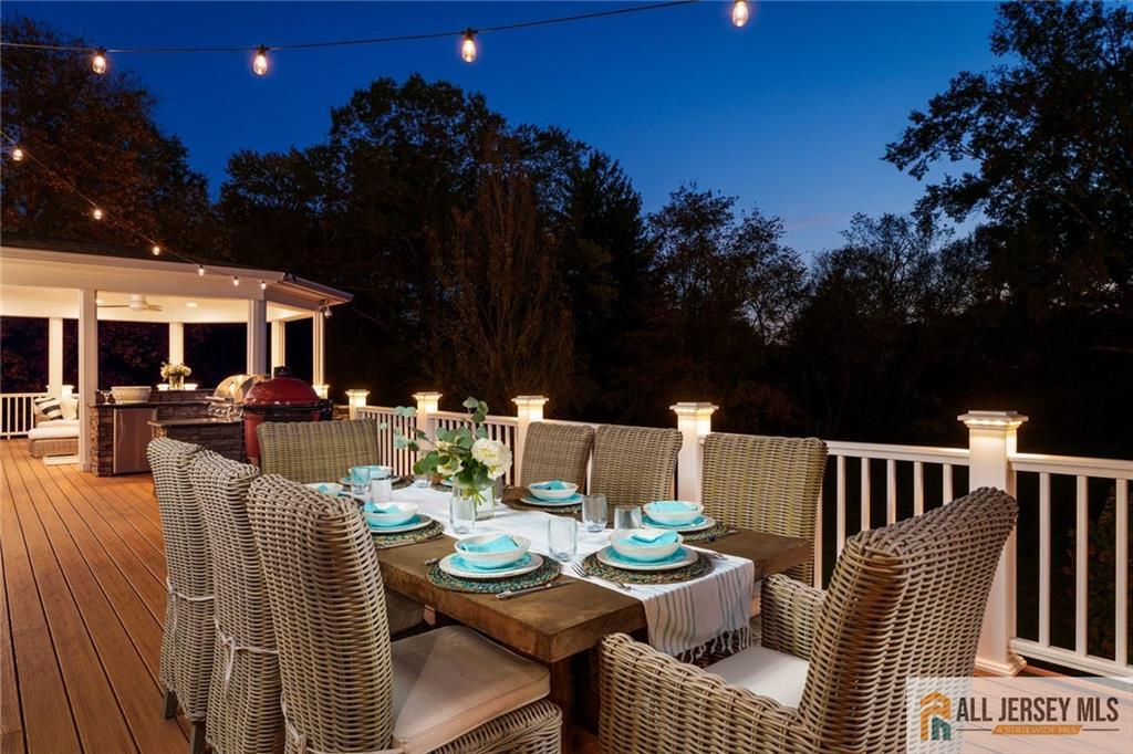 213 Cranbury Neck Road Plainsboro, NJ 08512 - Photo 47 of 52 a view of a patio with dining table and chairs with a fire pit