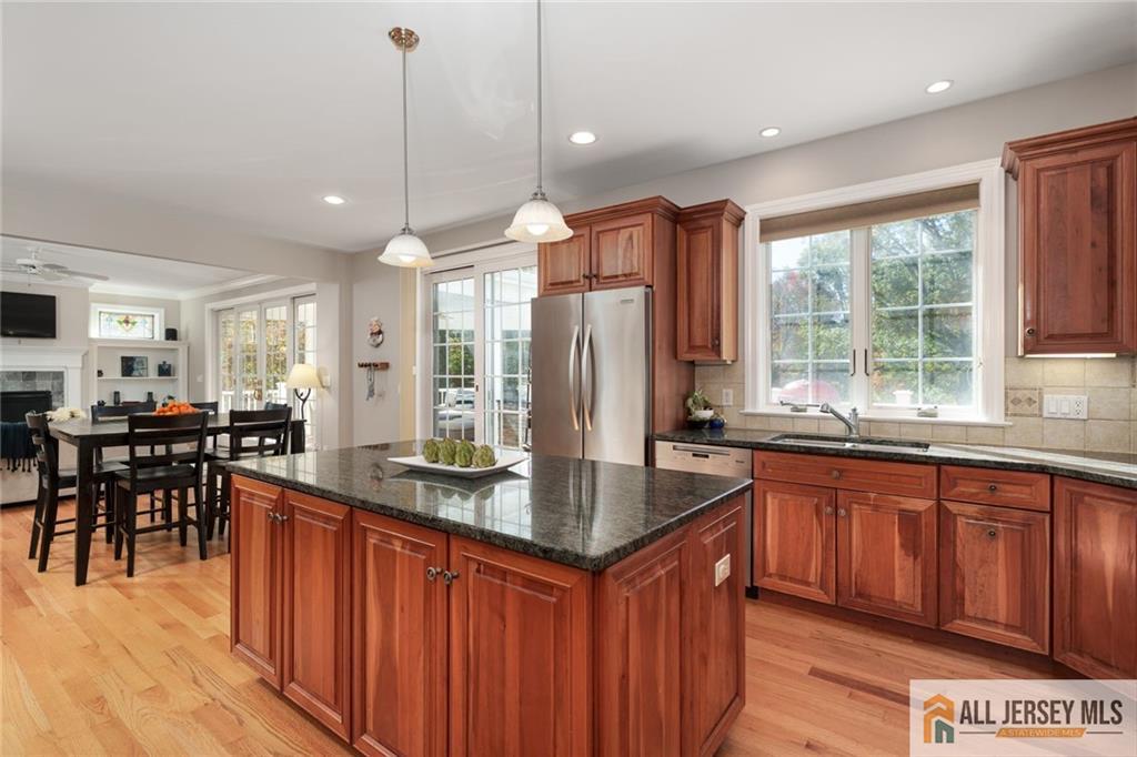 213 Cranbury Neck Road Plainsboro, NJ 08512 - Photo 8 of 52 a kitchen with stainless steel appliances granite countertop a sink a stove and a wooden cabinets
