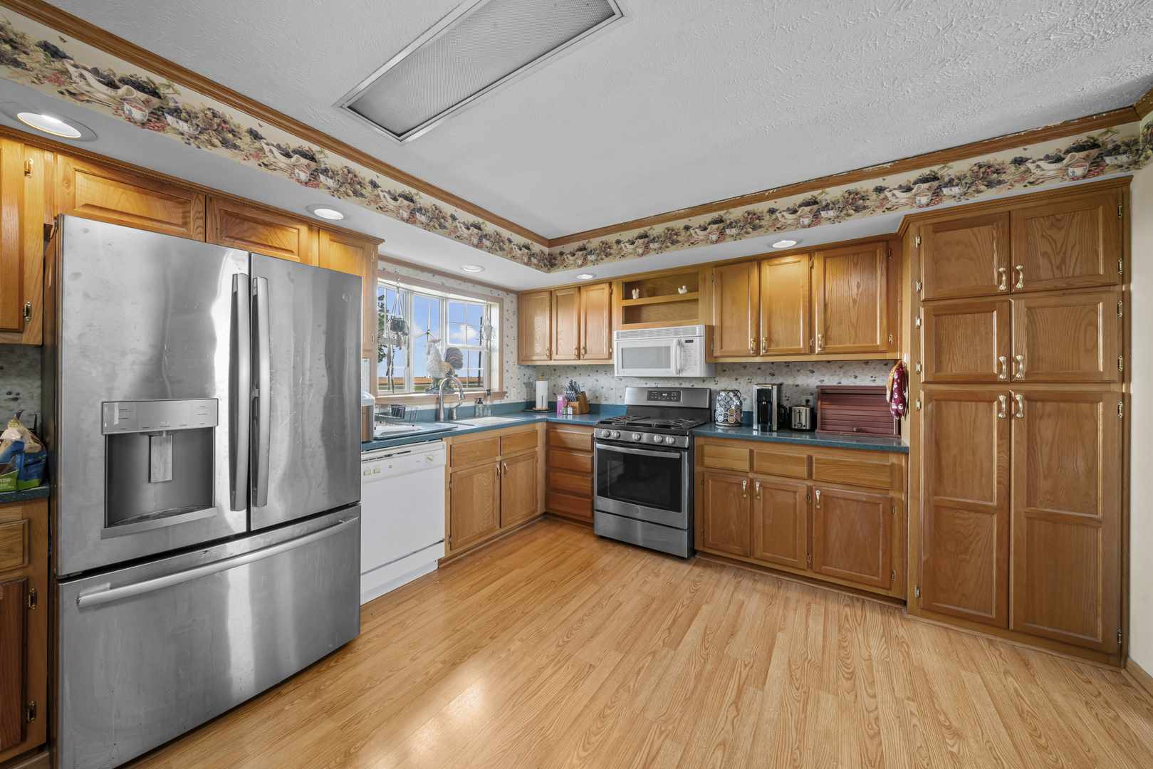 627 German Road Paw Paw, IL 61353 - Photo 14 of 45 a kitchen with granite countertop stainless steel appliances and wooden cabinets