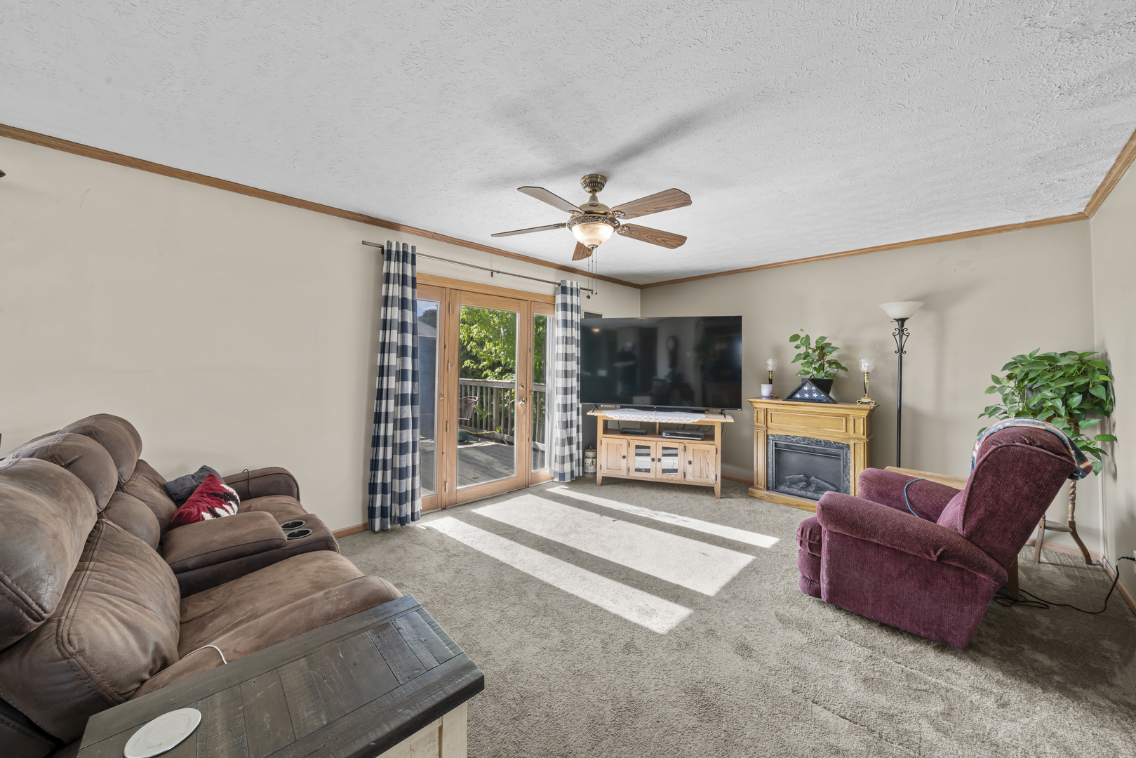 627 German Road Paw Paw, IL 61353 - Photo 10 of 45 a living room with furniture a flat screen tv and a floor to ceiling window