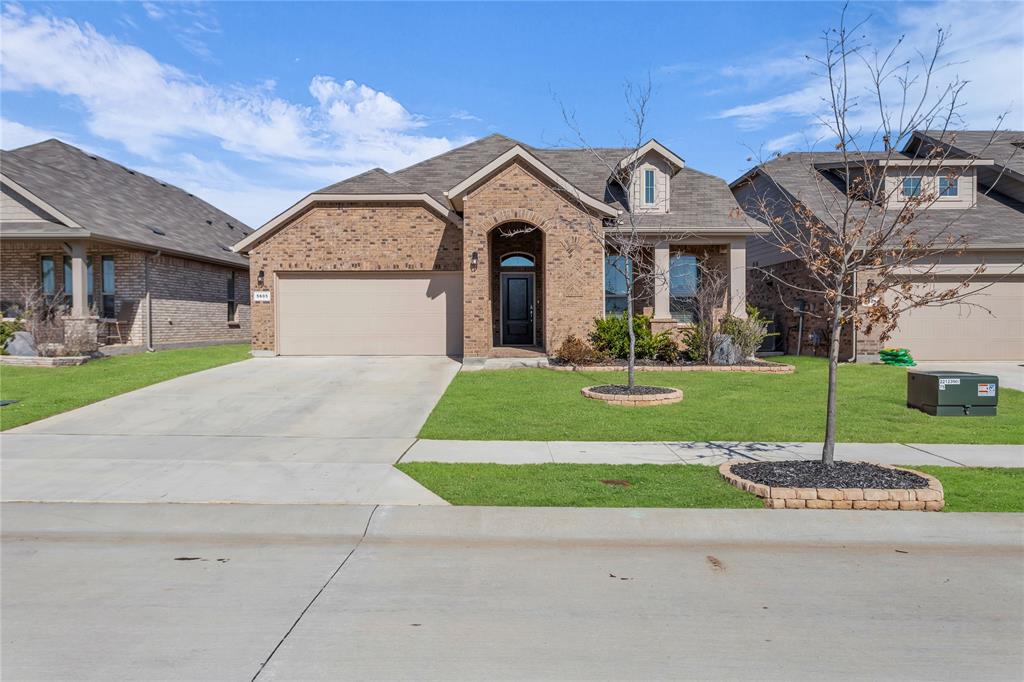 5605 Round Hl Road Denton, TX 76210 - Photo 1 of 1 View of front facade featuring a garage, brick siding, driveway, roof with shingles, and a front lawn