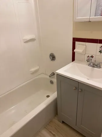 a bathroom with a bathtub and a shower