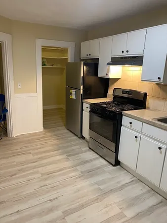 a kitchen with granite countertop a stove and a refrigerator