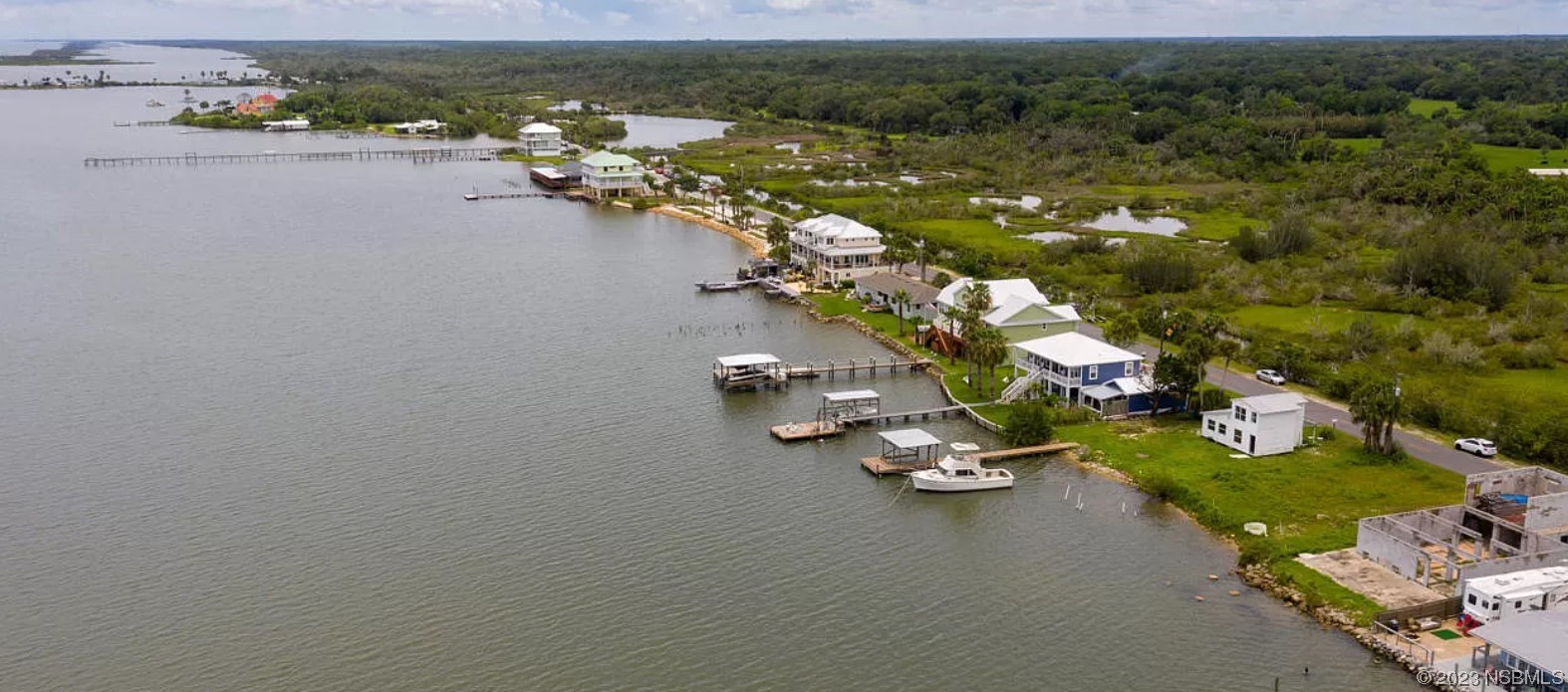 303 River Road Oak Hill, FL 32759 - Photo 4 of 5 an aerial view of a house with yard swimming pool and lake view