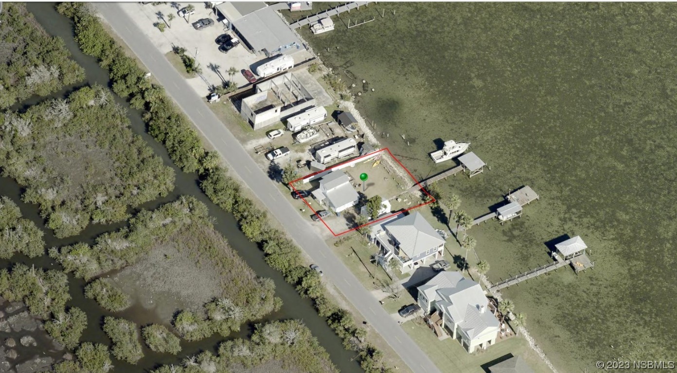 303 River Road Oak Hill, FL 32759 - Photo 5 of 5 an aerial view of a house with a yard