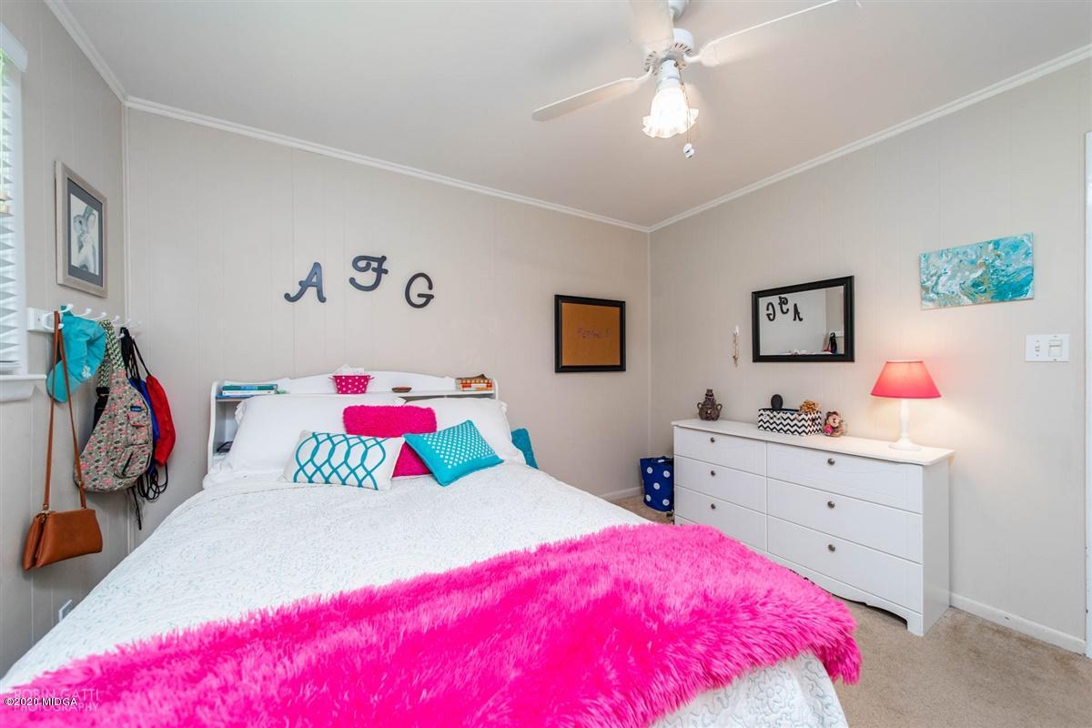 245 Plentitude Church Road Gray, GA 31032 - Photo 19 of 31 a bedroom with a bed and a dresser in it
