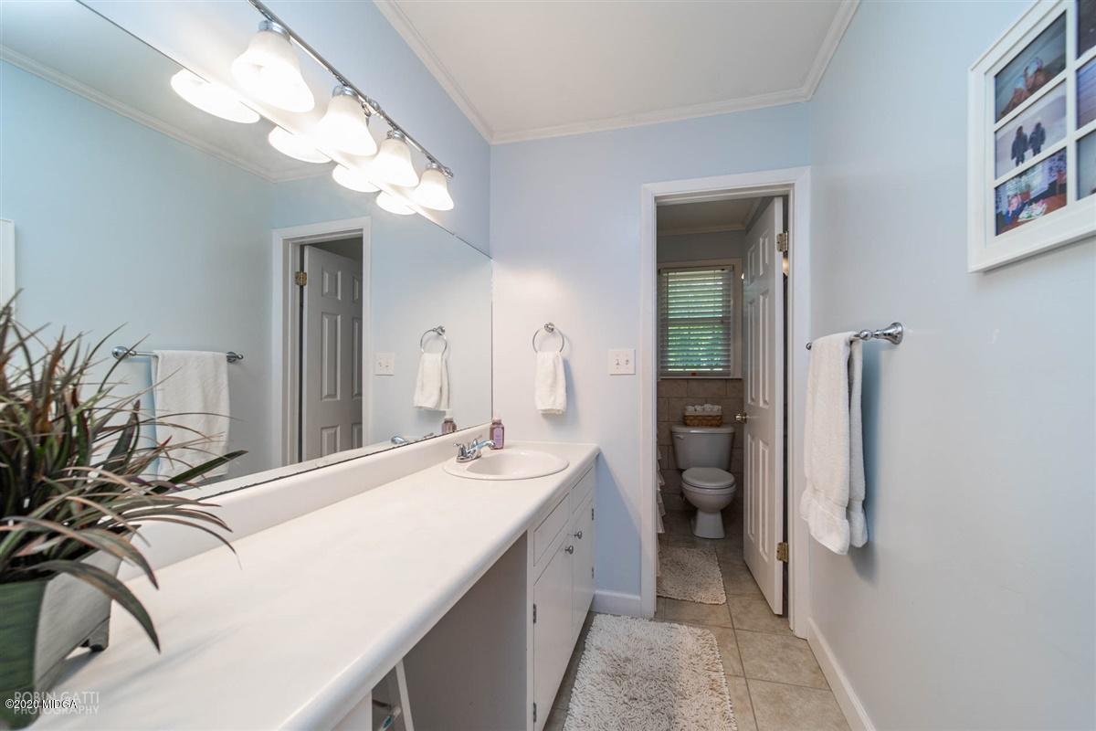 245 Plentitude Church Road Gray, GA 31032 - Photo 20 of 31 a spacious bathroom with a double vanity sink and a mirror
