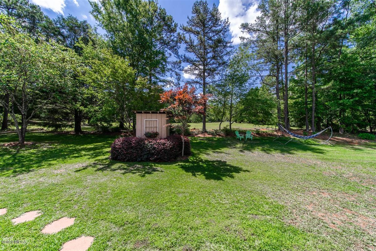 245 Plentitude Church Road Gray, GA 31032 - Photo 4 of 31 a backyard of a house with garden and trees