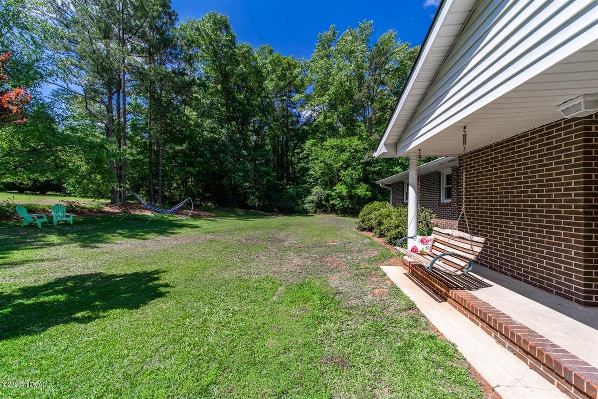 245 Plentitude Church Road Gray, GA 31032 - Photo 5 of 31 a backyard of a house with lots of green space