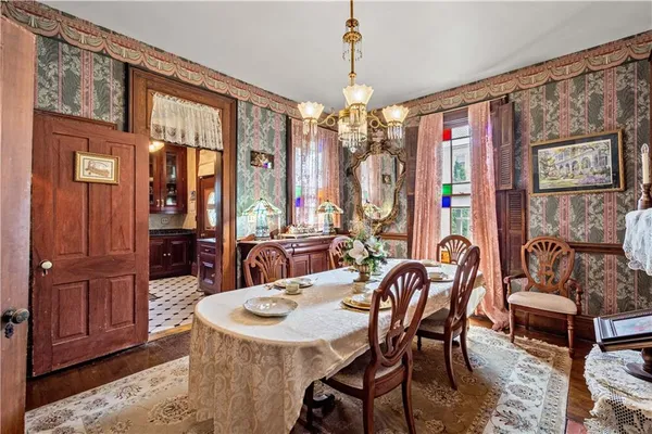 a view of a dining room with furniture and chandelier