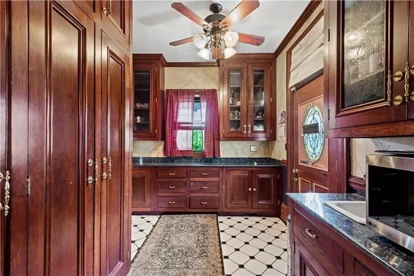 a kitchen with stainless steel appliances granite countertop a stove and a wooden cabinets