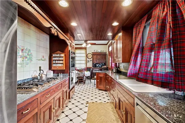 a kitchen with stainless steel appliances a stove and a microwave