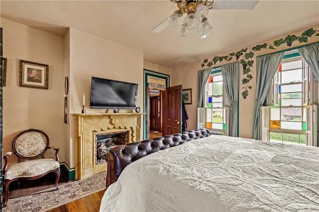 a bathroom with a granite countertop sink a toilet a mirror and shower