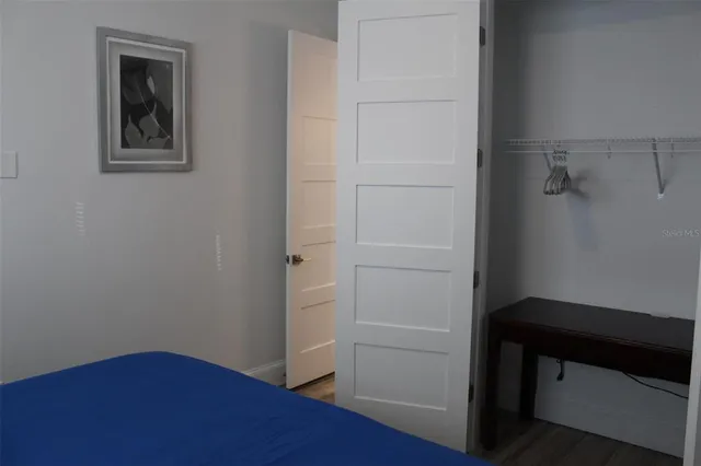 a view of kitchen with refrigerator cabinets and wooden floor