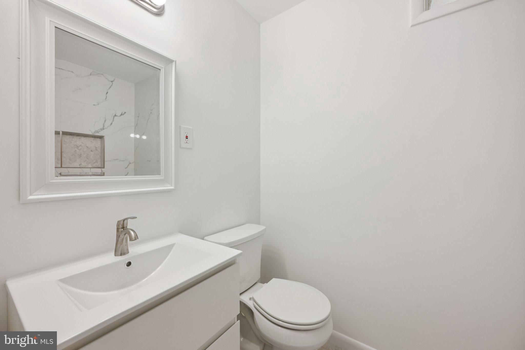 9801 Arbor Hill Drive Silver Spring, MD 20903 - Photo 18 of 28 Sleek, modern bathroom with elegant finishes.