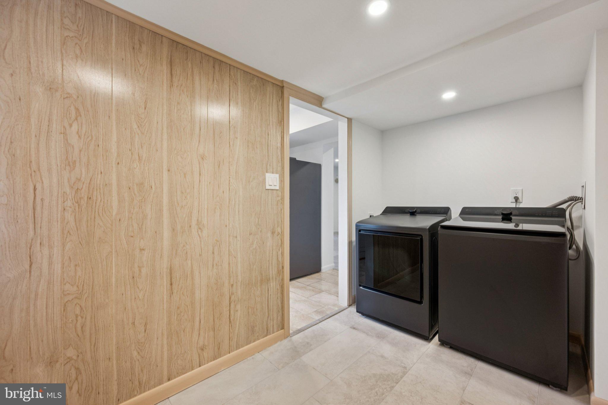 9801 Arbor Hill Drive Silver Spring, MD 20903 - Photo 19 of 28 Modern laundry space with sleek appliances.
