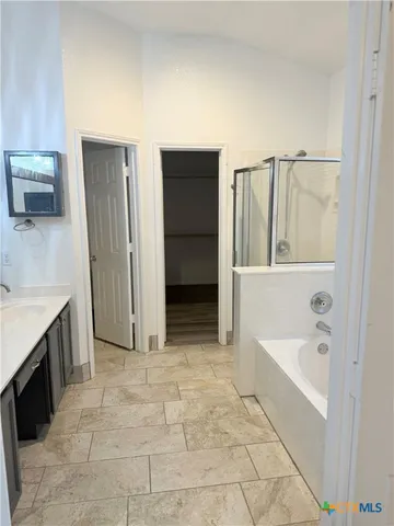 a bathroom with a tub sink and mirror