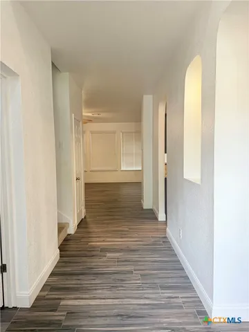 a view of a room with wooden floor and staircase