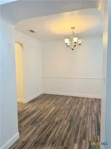 a view of a room with wooden floor