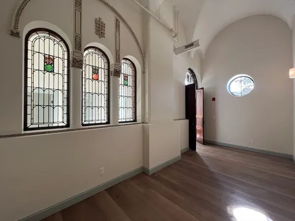 a view of a livingroom with wooden floor and window