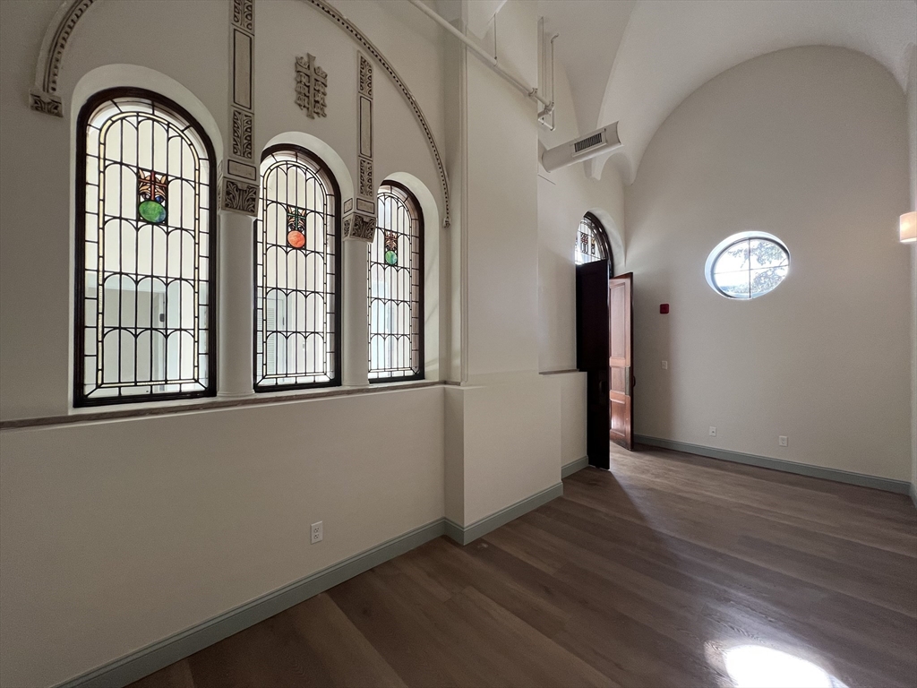 a view of a livingroom with wooden floor and window