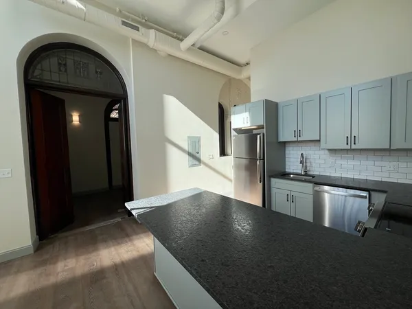 a view of entryway with kitchen