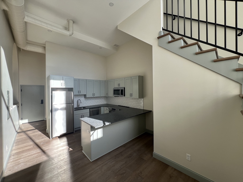 160 Seabury Street, Unit 37 Fall River, MA 02720 - Photo 7 of 13 a kitchen with stainless steel appliances granite countertop a sink and a refrigerator