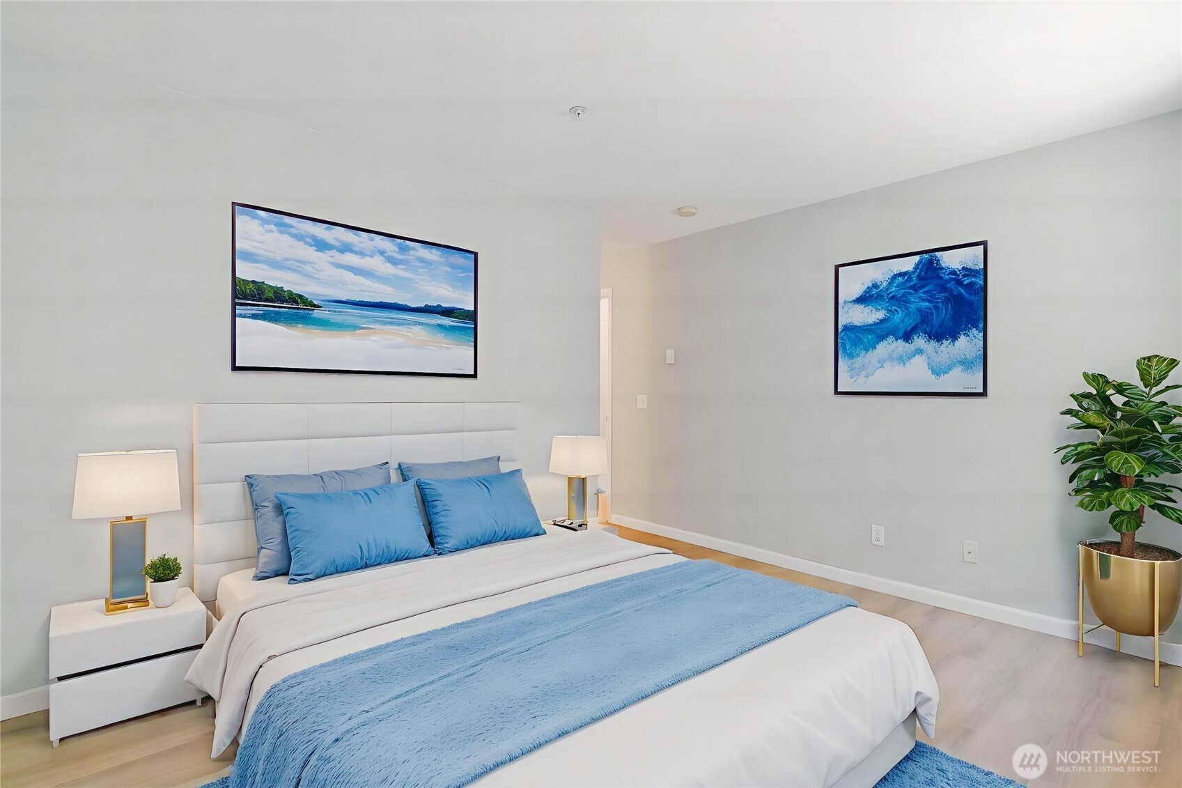 33020 10th Avenue Southwest, Unit Z203 Federal Way, WA 98023 - Photo 14 of 25 a bedroom with bed and paintings on the wall