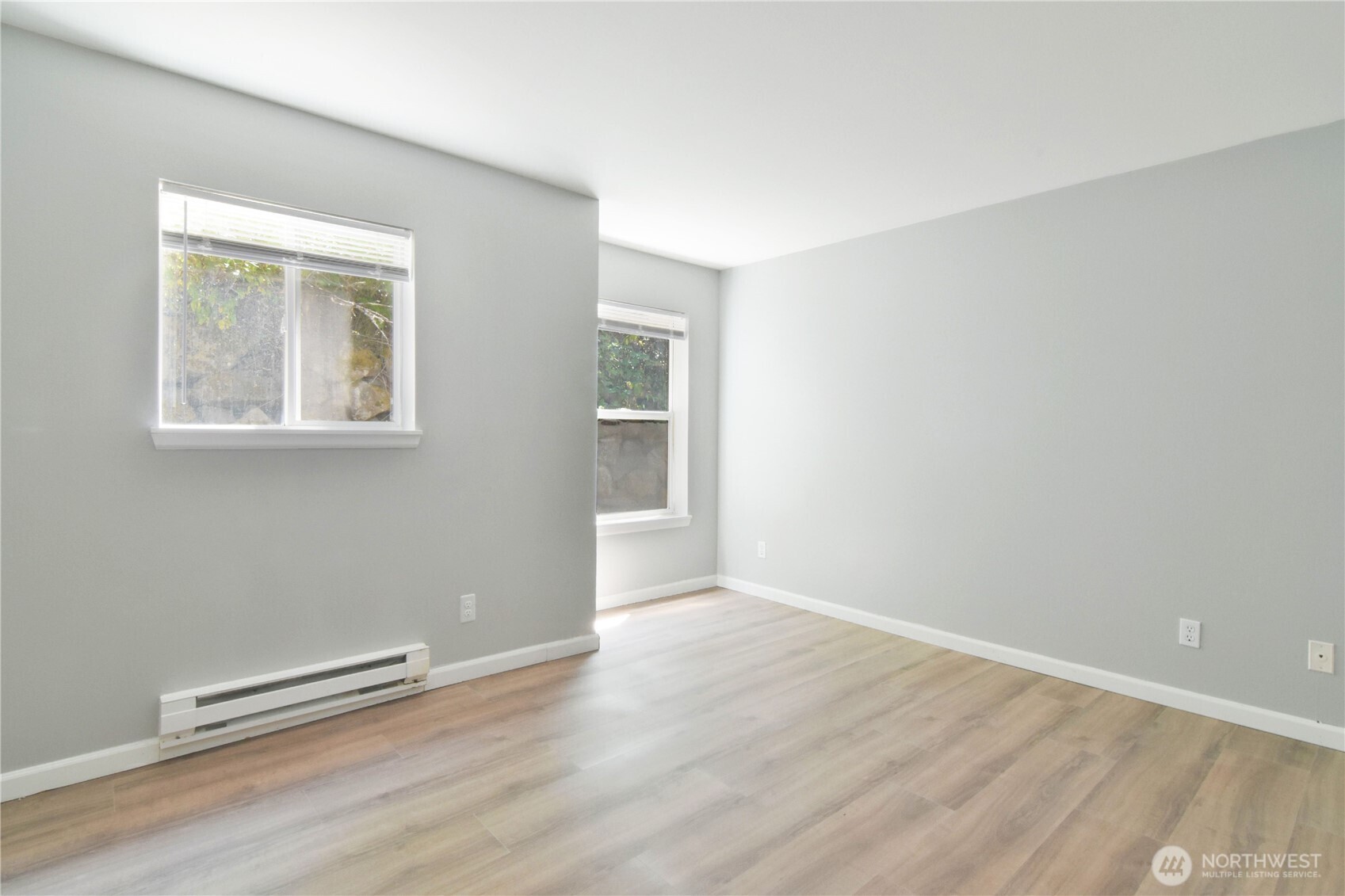 33020 10th Avenue Southwest, Unit Z203 Federal Way, WA 98023 - Photo 16 of 25 an empty room with wooden floor and windows