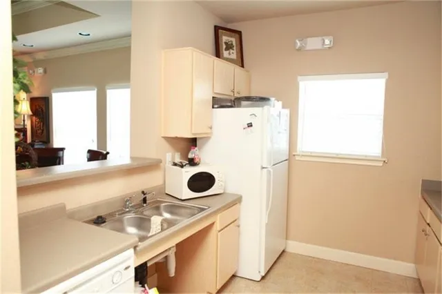 a kitchen with a sink and a refrigerator