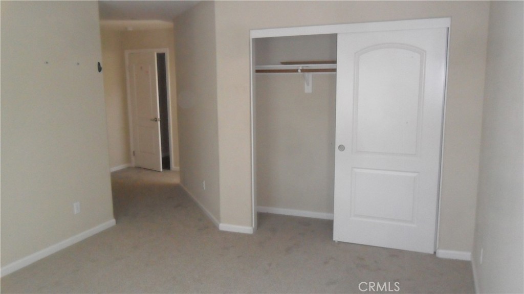 36277 Waxen Road Lake Elsinore, CA 92532 - Photo 13 of 27 an empty room with closet and a hallway