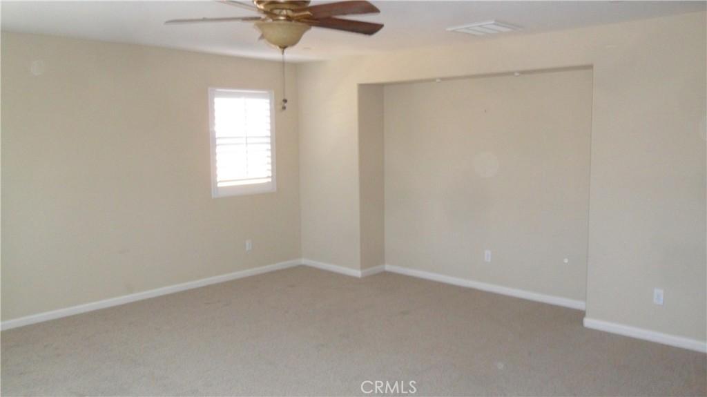 36277 Waxen Road Lake Elsinore, CA 92532 - Photo 15 of 27 an empty room with a window and a fan
