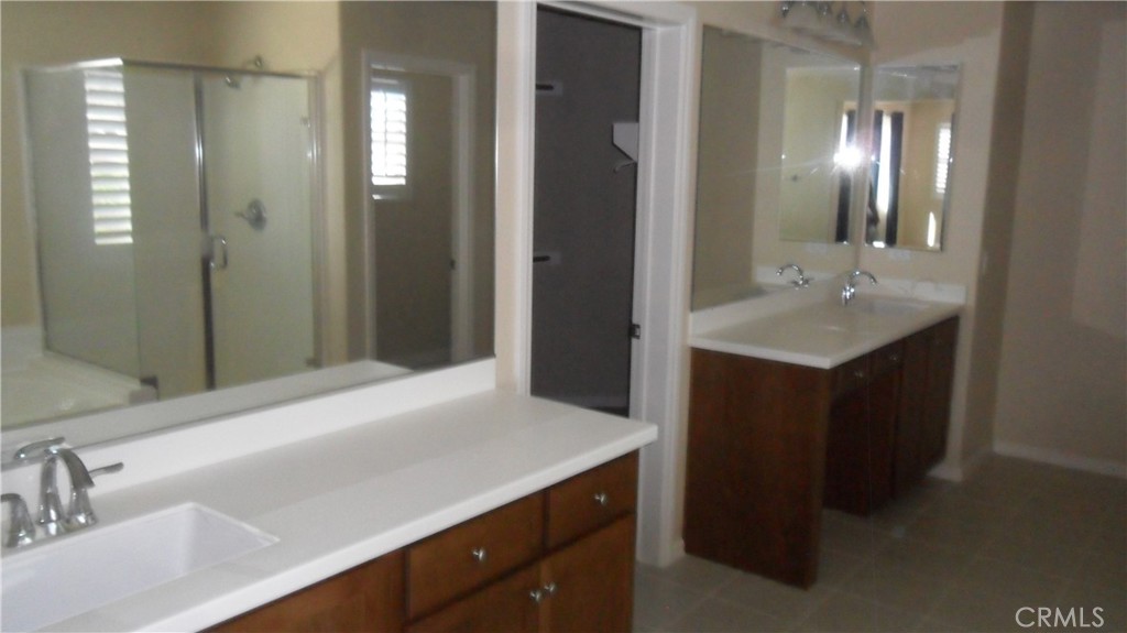 36277 Waxen Road Lake Elsinore, CA 92532 - Photo 16 of 27 a bathroom with a sink and a mirror