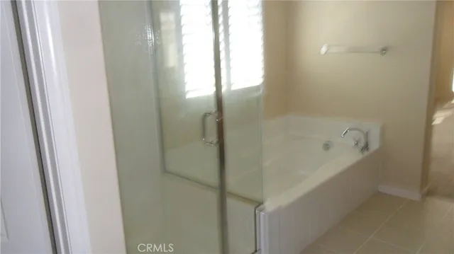 a bathroom with a bathtub and shower