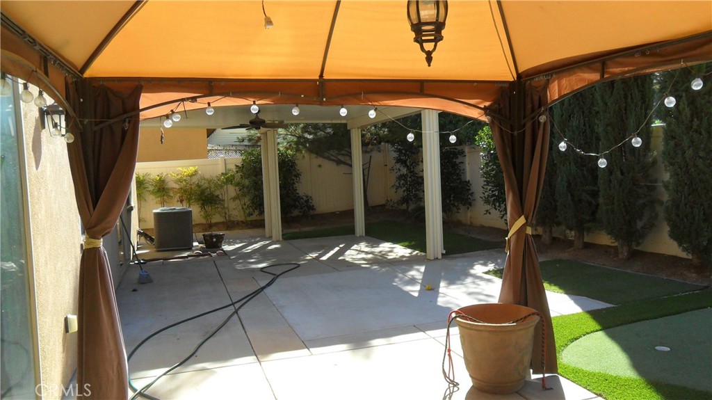 36277 Waxen Road Lake Elsinore, CA 92532 - Photo 25 of 27 a view of a patio with table and chairs potted plants