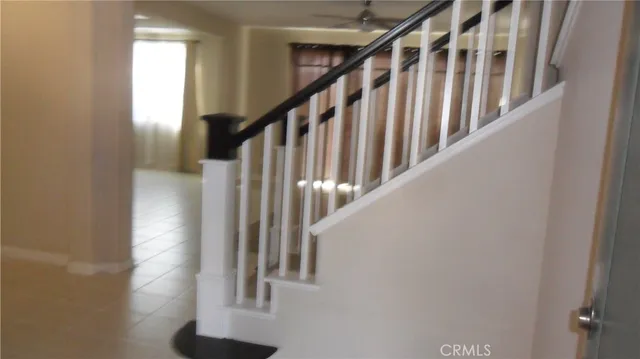 a view of staircase with white walls and a window