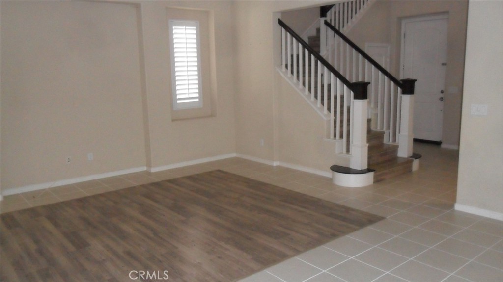 36277 Waxen Road Lake Elsinore, CA 92532 - Photo 4 of 27 an empty room with wooden floor and windows