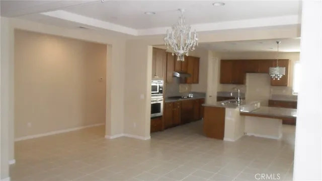 a view of a kitchen with a sink and cabinets