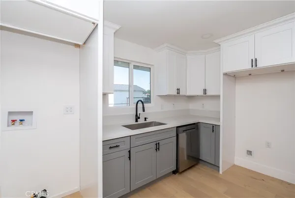 a kitchen with a sink cabinets and window